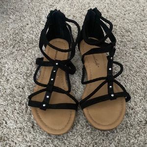 Black open toed sandals with a little silver.